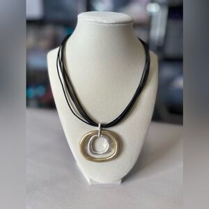 leather strsps with a hold and Silver pendant